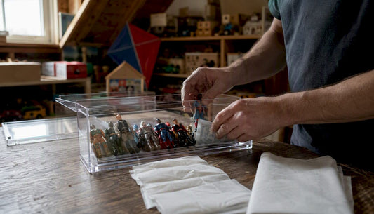 Hands packing action figures into storage case