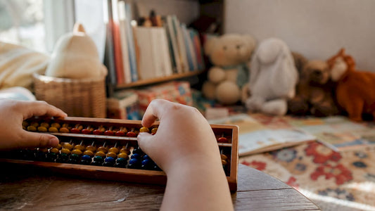 Child hands sliding soroban abacus beads