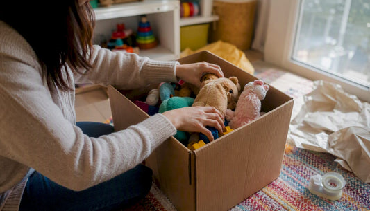 Hands packing toys into shipping box