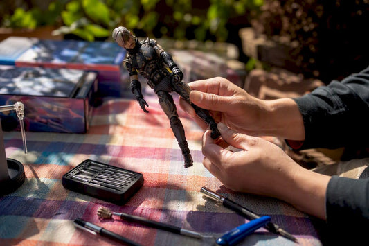 Hands adjusting articulated figure ankle joint