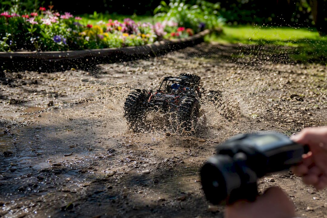 RC toy car splashing water in puddle