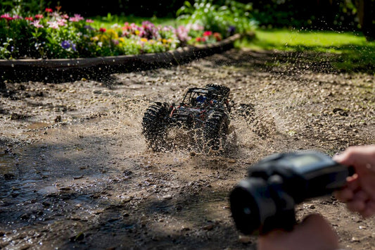 RC toy car splashing water in puddle