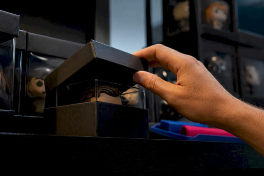 Collector inspecting a rare boxed figure