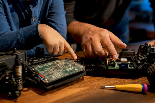 Parent and child examining RC electronics
