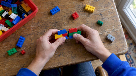 Hands testing compatible building bricks