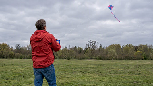 Parent testing a kite line in light wind