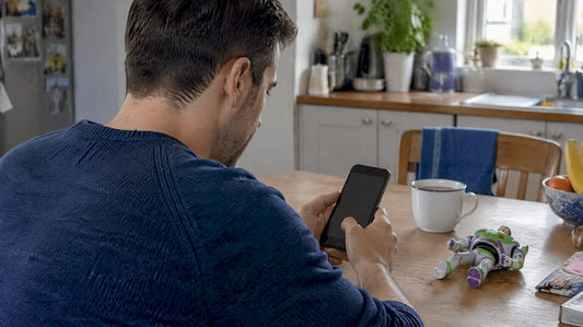 Parent placing a toy preorder on a phone