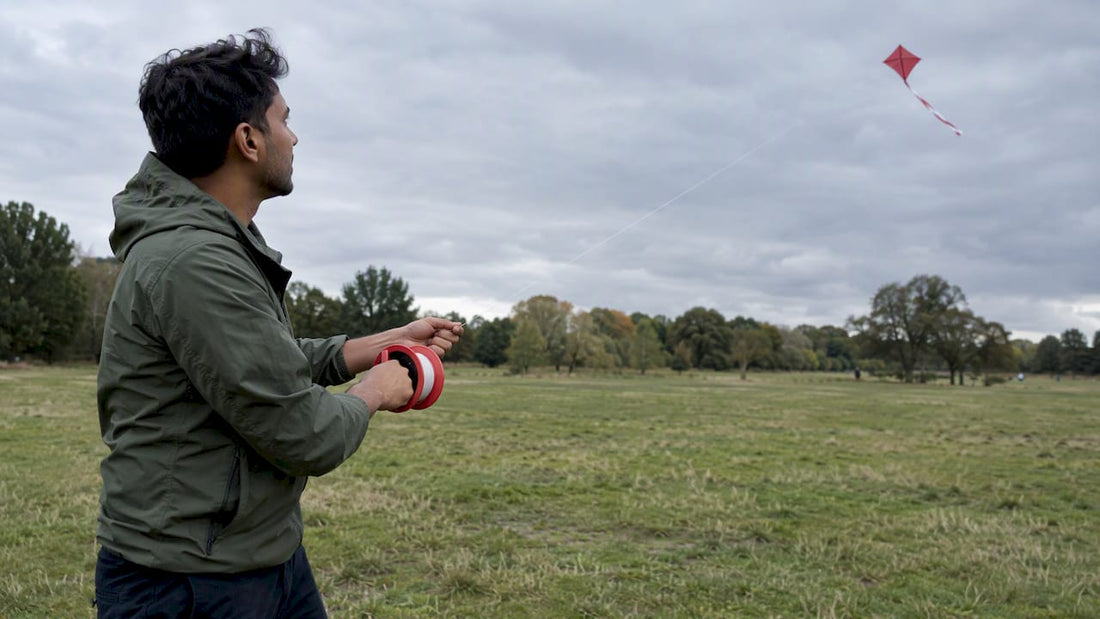 Kite flyer guiding line from a red reel
