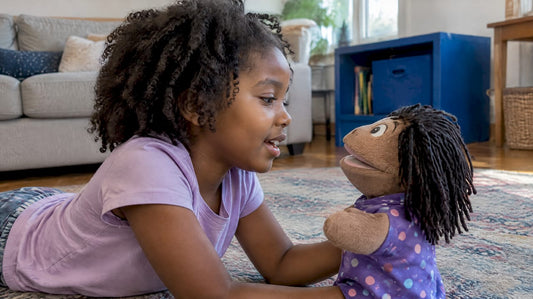 Child speaking to a hand puppet during play